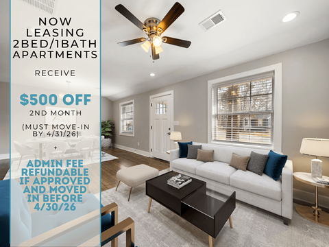 A living room with a ceiling fan and a couch.