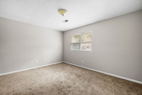 Carpeted Bedroom at Bradford Gwinnett Apartments and Townhomes, Norcross