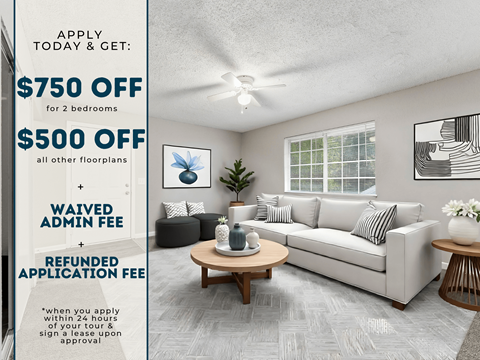 A room with a couch, a coffee table, and a ceiling fan.