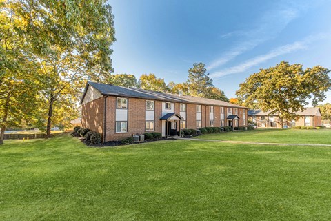 Two story brick buildings with spacious green lawn at Ridgewood Apartments, Georgia, 30045