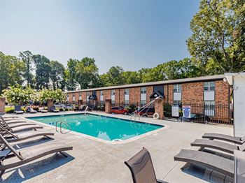 our apartments offer a swimming pool and a patio with chairs