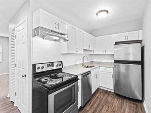 Upgraded kitchen with white cabinets and stainless steel appliances at Georgian Oaks Apartments l & ll* Apartments, Georgia