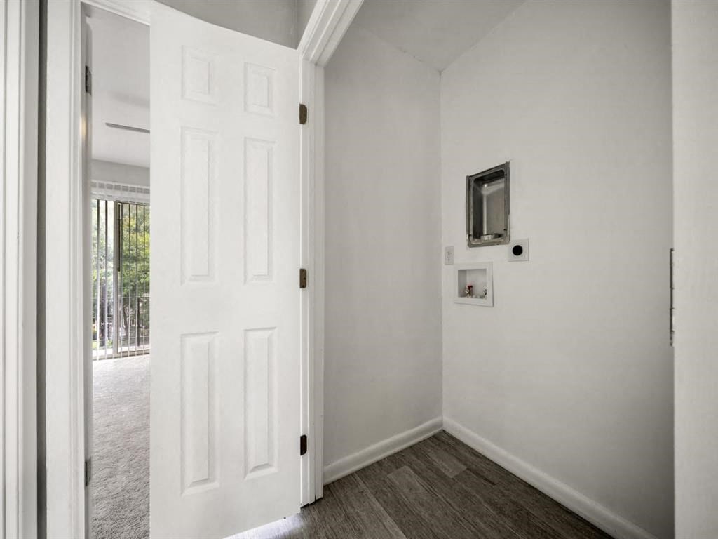 a white room with a white door and a television