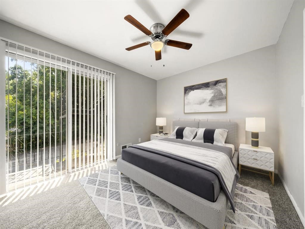 a bedroom with a bed and a ceiling fan