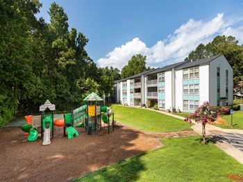 a playground in front of an apartment building