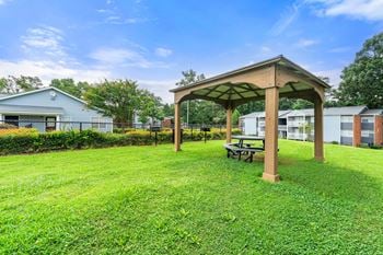 a gazebo with a picnic table in the grass at 445 Cleveland, Atlanta Georgia