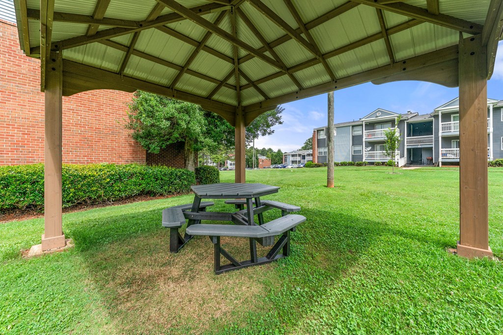 a picnic table sitting under a pavilion in the grass at 445 Cleveland, Georgia, 30354