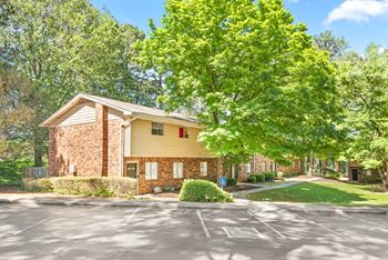 apartments surrounded by lush greenery and trees at Northgate Townhomes in GA 30084