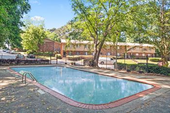 a swimming pool with a building in the background at Northgate Townhomes in Tucker, 30084