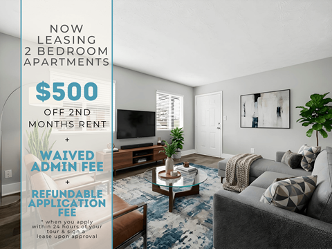 A living room with a sign advertising a 2 bedroom apartment for rent at $500 off 2nd month rent.