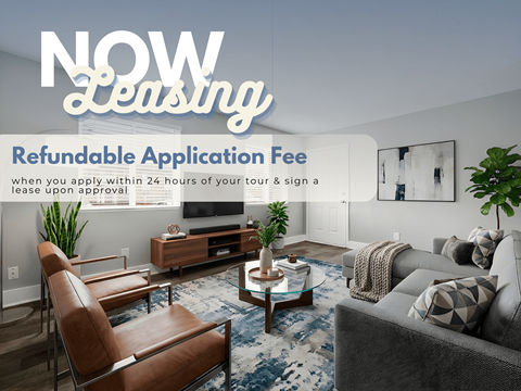 A living room with a sofa, chair, and coffee table with a sign that says "NOW Leasing" and "Refundable Application Fee".