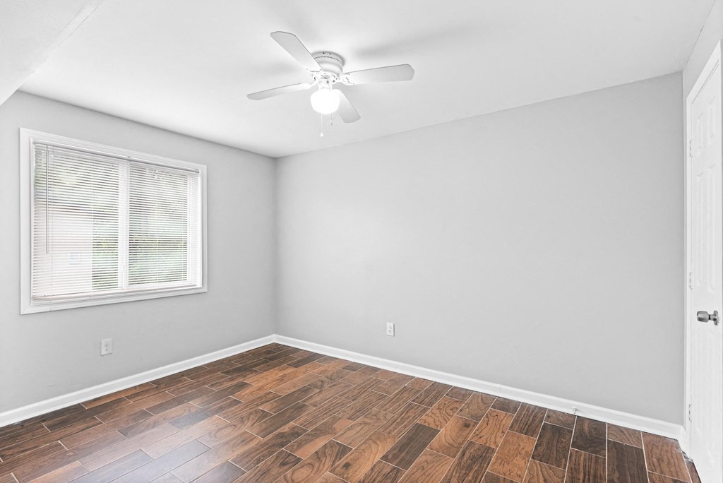 Light and airy bedroom with ceiling fan and a window at Gardens at Washington Park, Atlanta