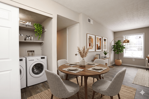 A dining room with a table set for four and a laundry room with a washer and dryer.