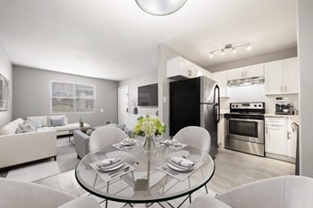 a living room with a glass table and a kitchen with stainless steel appliances at Georgian Oaks Apartments Apartments, Smyrna , 30080