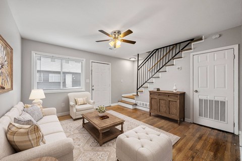 A living room with a couch, chair, and coffee table.