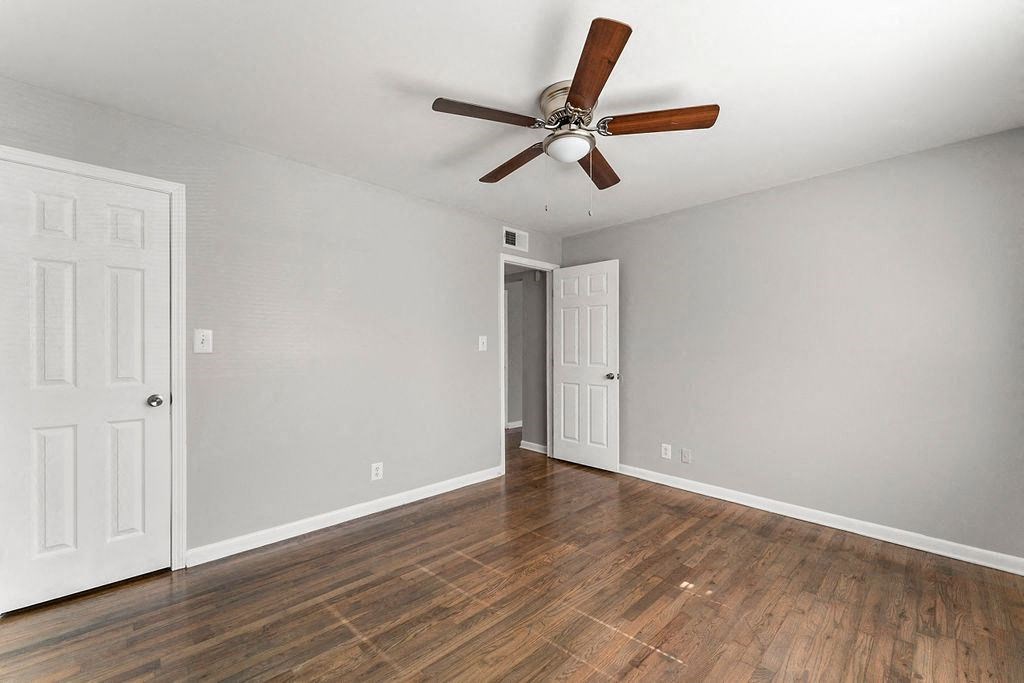 Bedroom with hardwood floors and a ceiling fan Bedroom with hardwood floors and a ceiling fan at Gardens at Washington Park, Georgia