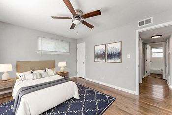 a bedroom with a bed and a ceiling fan at Gardens at Washington Park, Georgia
