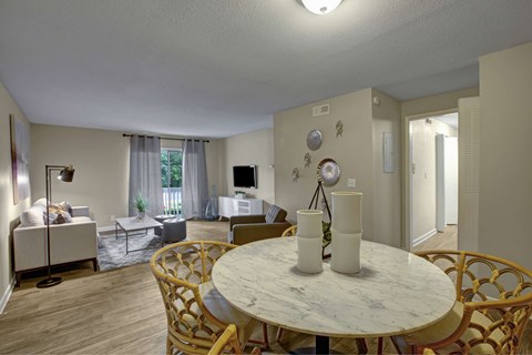 A living room with a white table and chairs.
