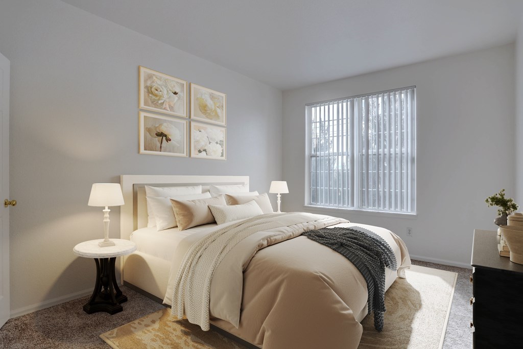 A bedroom with a large bed and a window with blinds.