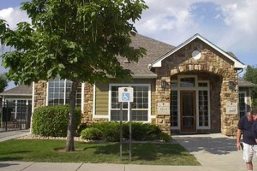 a man walking in front of a brick house