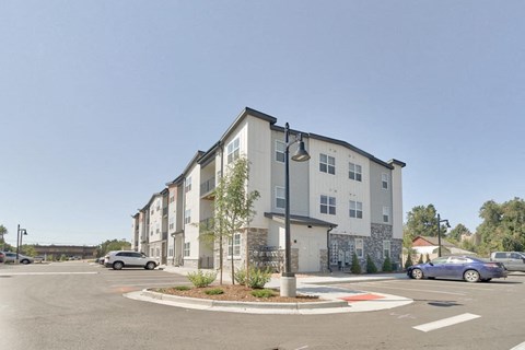 an empty parking lot in front of an apartment building