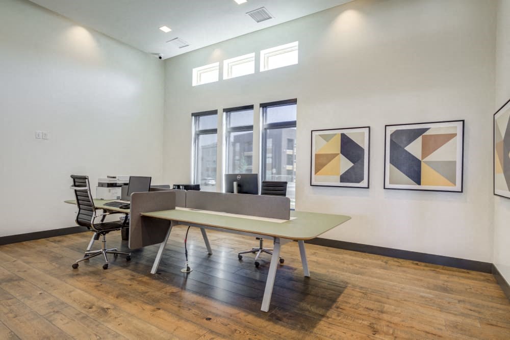 a conference room with a table and chairs and paintings on the wall