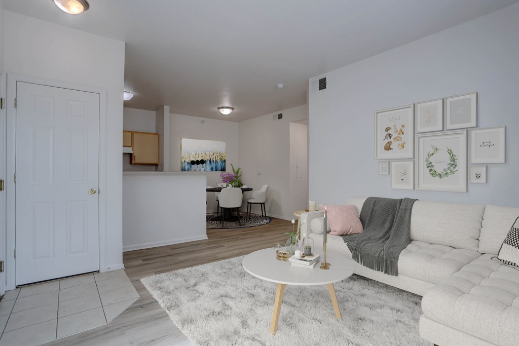 A living room with a white couch and a coffee table.