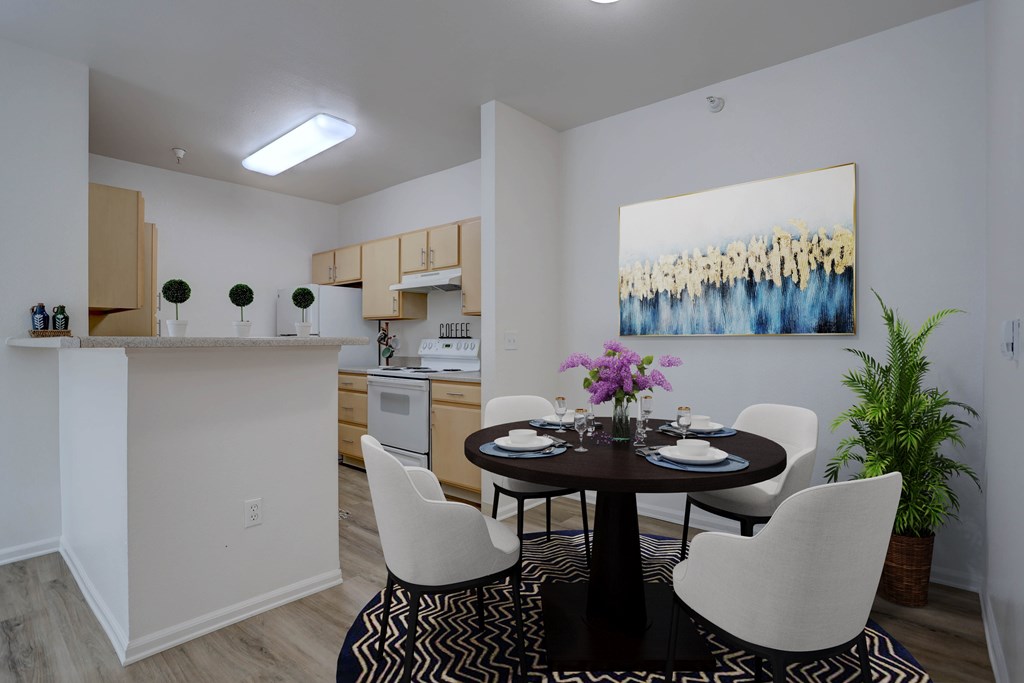 A dining room with a table set for four.