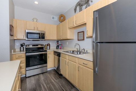 A kitchen with wooden cabinets and stainless steel appliances.