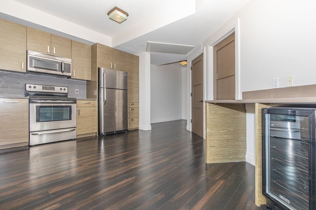 A kitchen with a stainless steel refrigerator and oven.