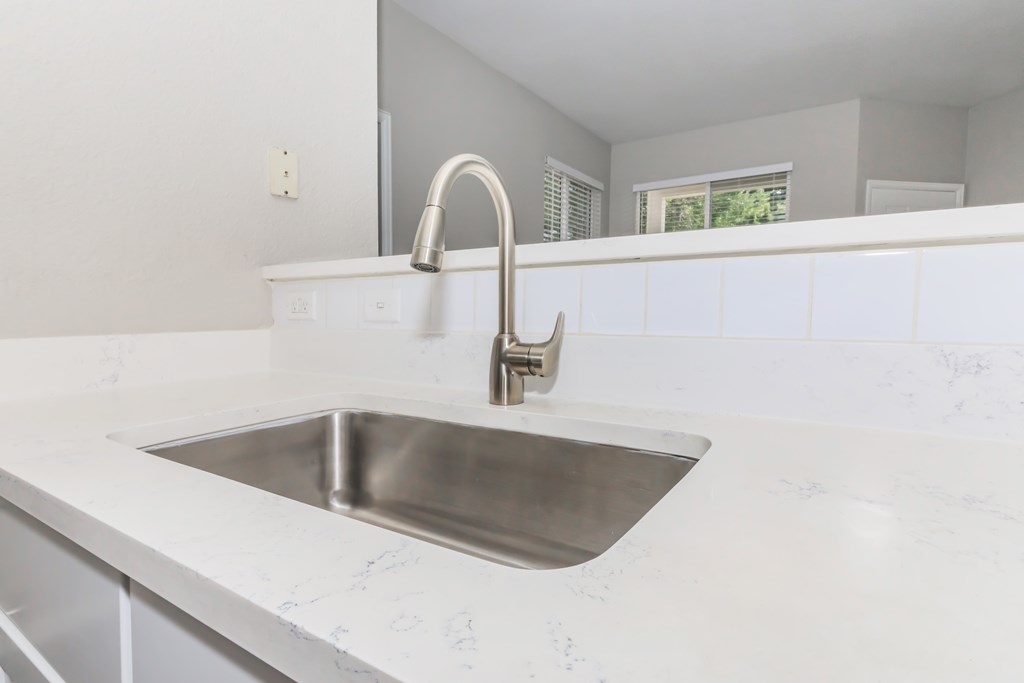 Farm style sink with backsplash.