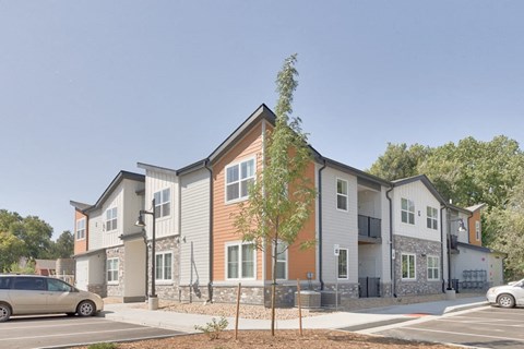 an apartment building with cars parked in front of it