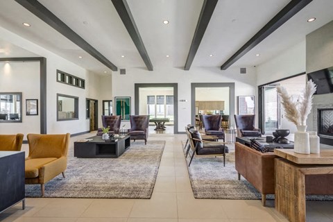 A modern living room with a large rug and a fireplace.