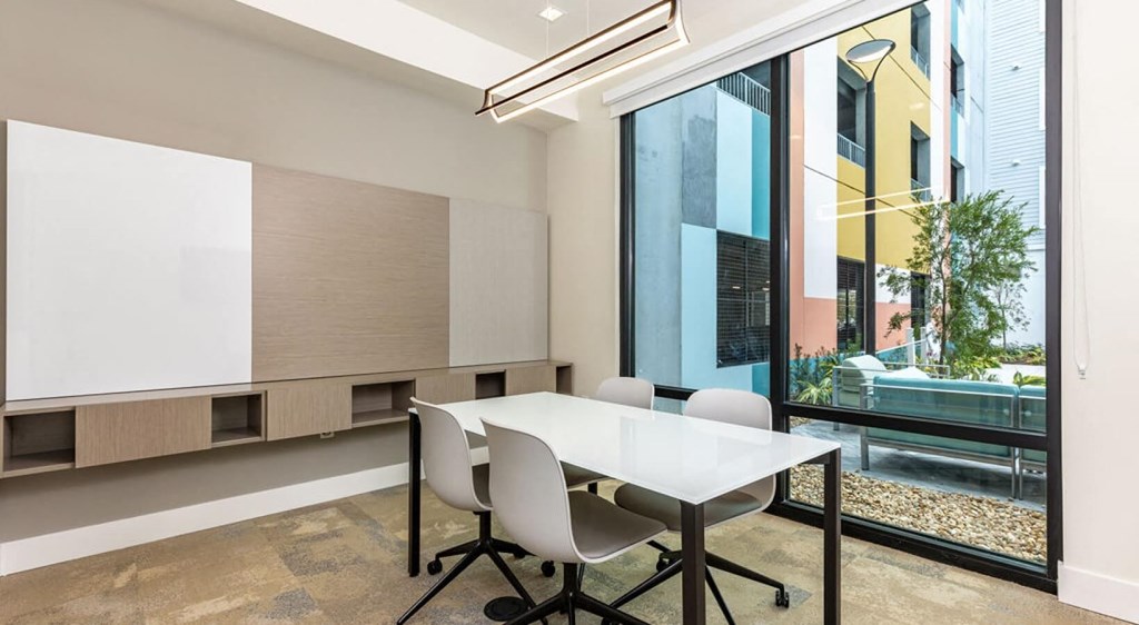 a conference room with a white table and chairs