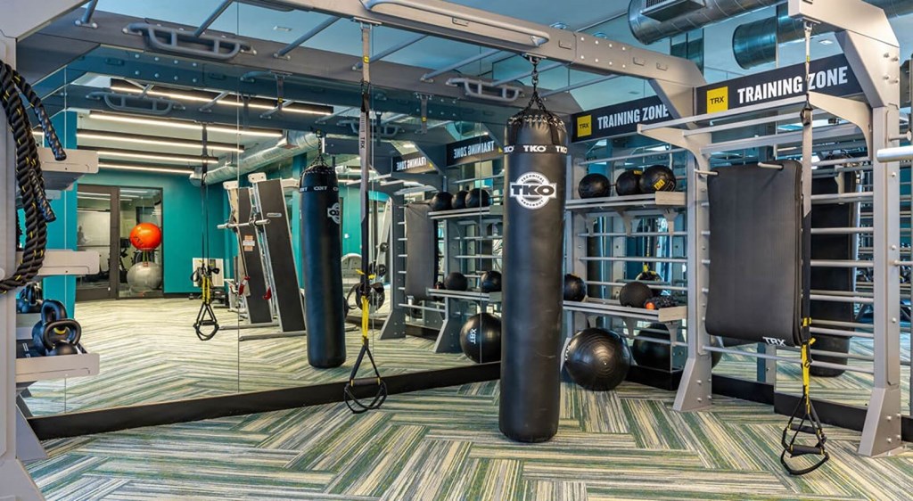 a gym with boxing punching bags and other gym equipment