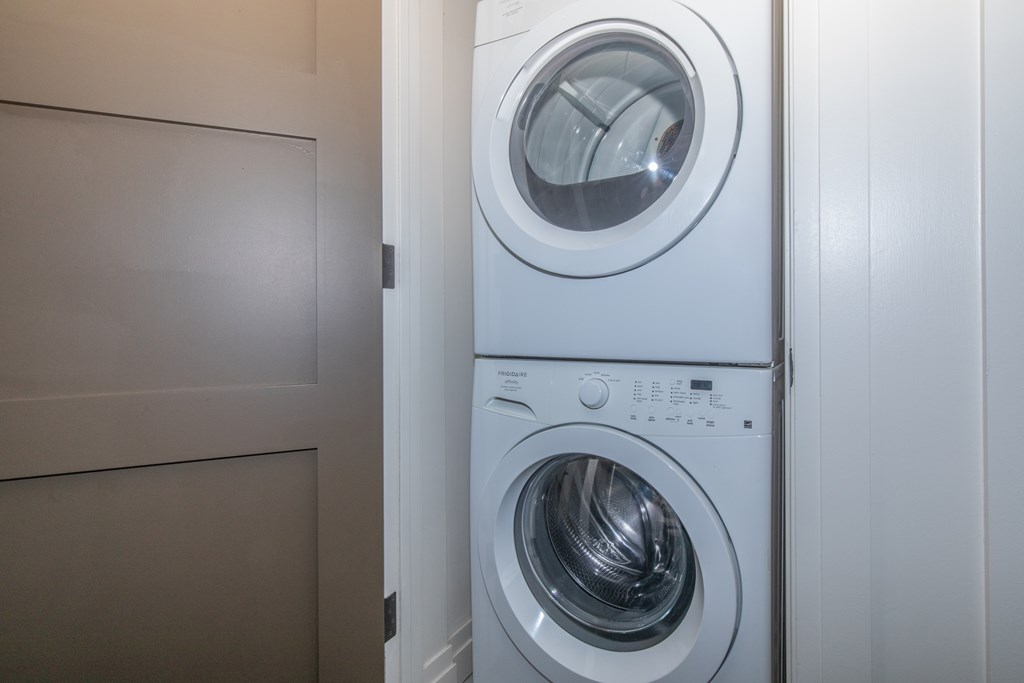 A white washing machine is placed in a laundry room.