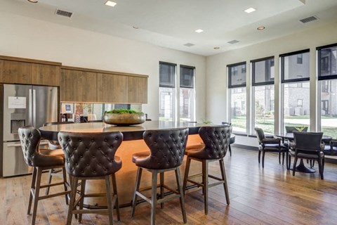 the kitchen has a large island with bar stools and chairs