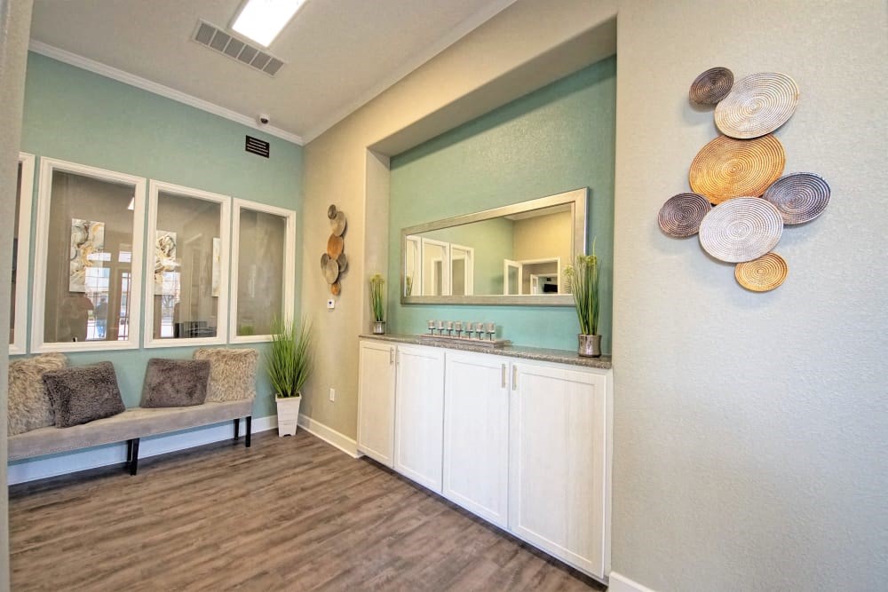 a living room with a couch and a mirror on the wall