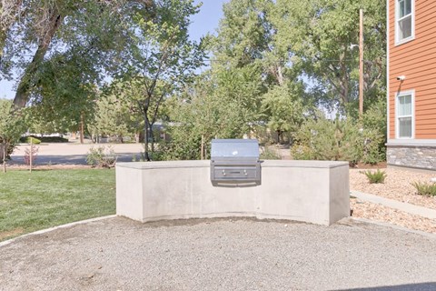 a mailbox on a concrete wall in front of a house
