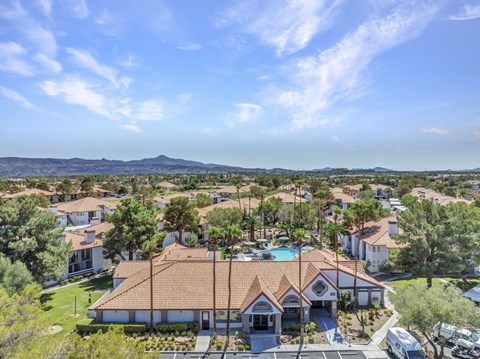 A bird's eye view of a residential area with houses and a swimming pool.