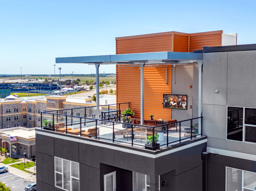 A modern building with a balcony and a view of the city.