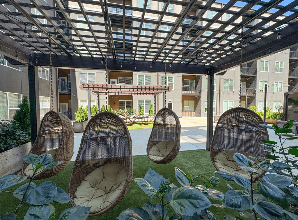 A patio with a roof and chairs.