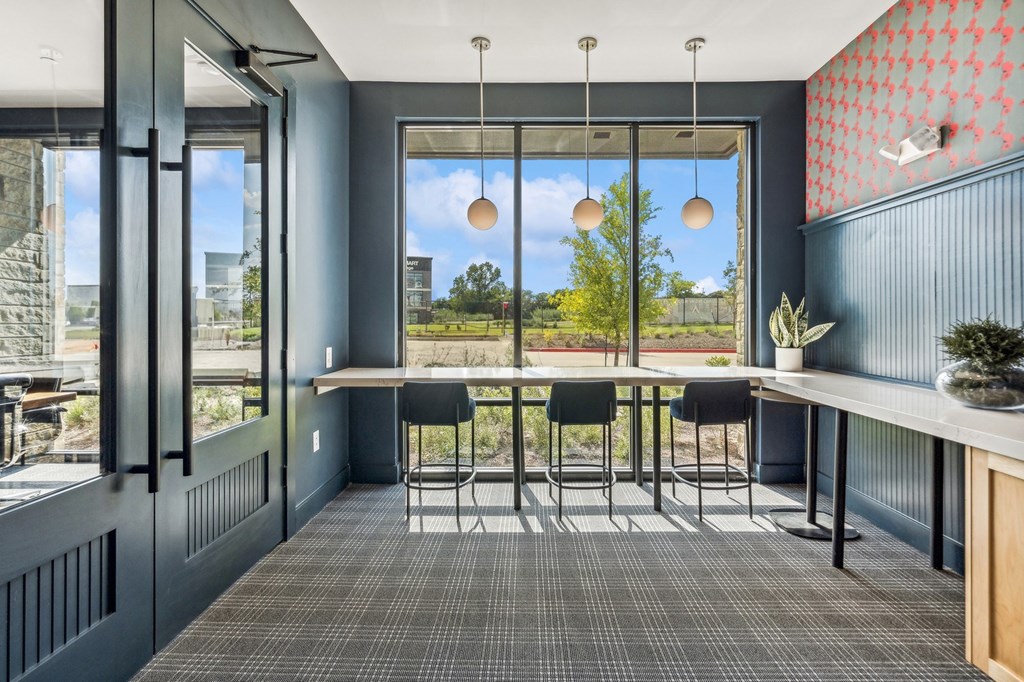 Business center with tables and chairs looking out onto the lawn