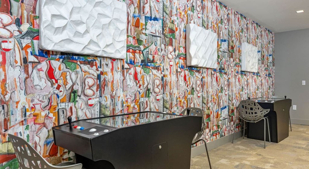 a game room with a pool table and a wall covered in graffiti