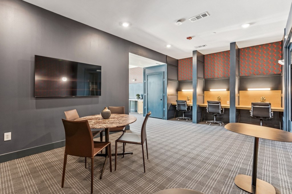 A conference room with a table and chairs.