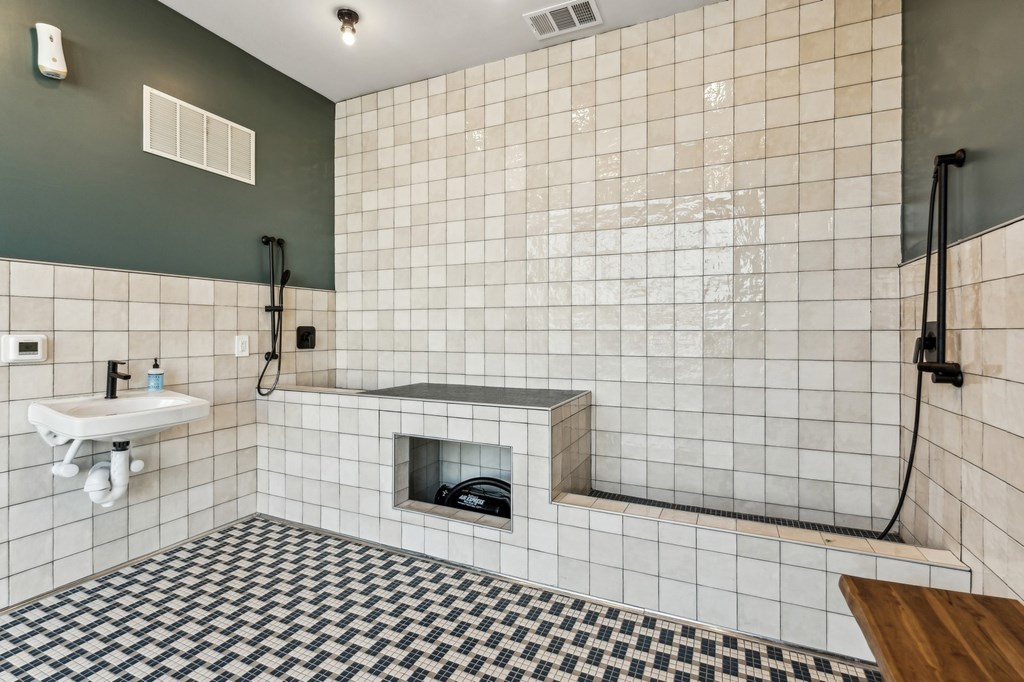 A bathroom with a black and white checkered floor.