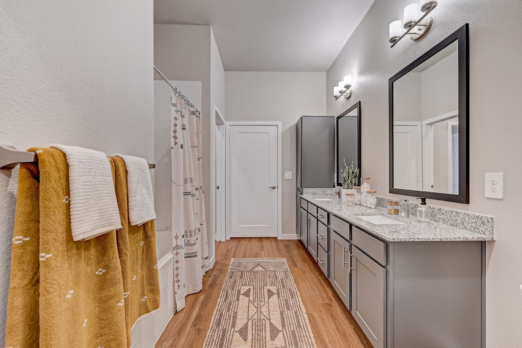 A bathroom with a towel hanging on the railing.