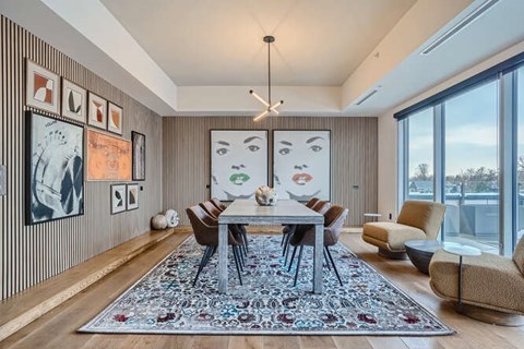 A modern dining room with a large table and chairs.