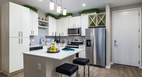 a kitchen with stainless steel appliances and white cabinets