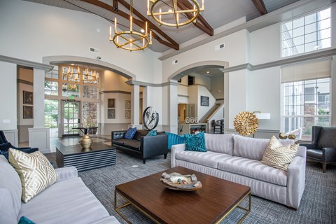A living room with a white couch and a coffee table.